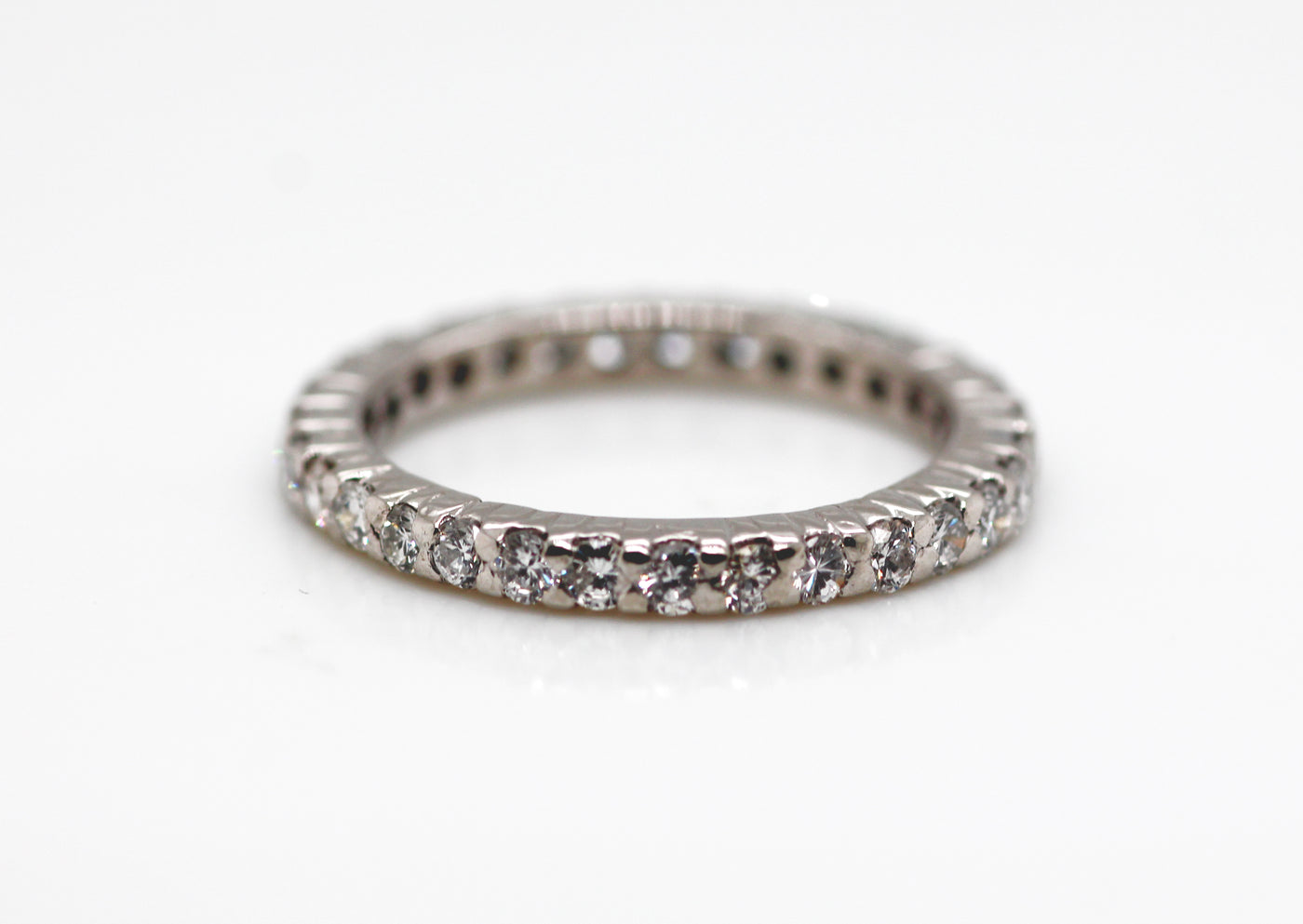 PLATINUM .93 CTTW DIAMOND ETERNITY BAND 
some chipped stones, AS IS