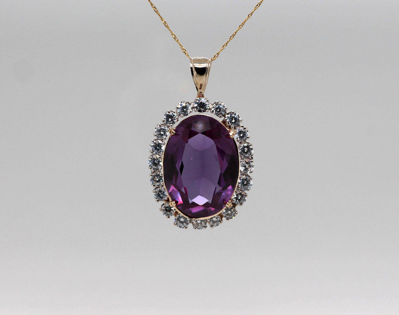 ESTATE 14KY 22.25 CT SYNTHETIC SAPPHIRE AND CZ PENDANT