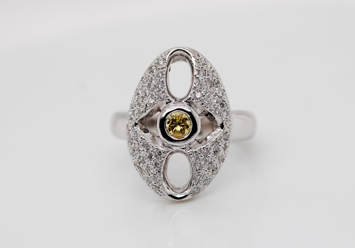18KW .62 CTTW DIAMOND FASHION RING .18 CT YELLOW ROUND CENTER DIAMOND