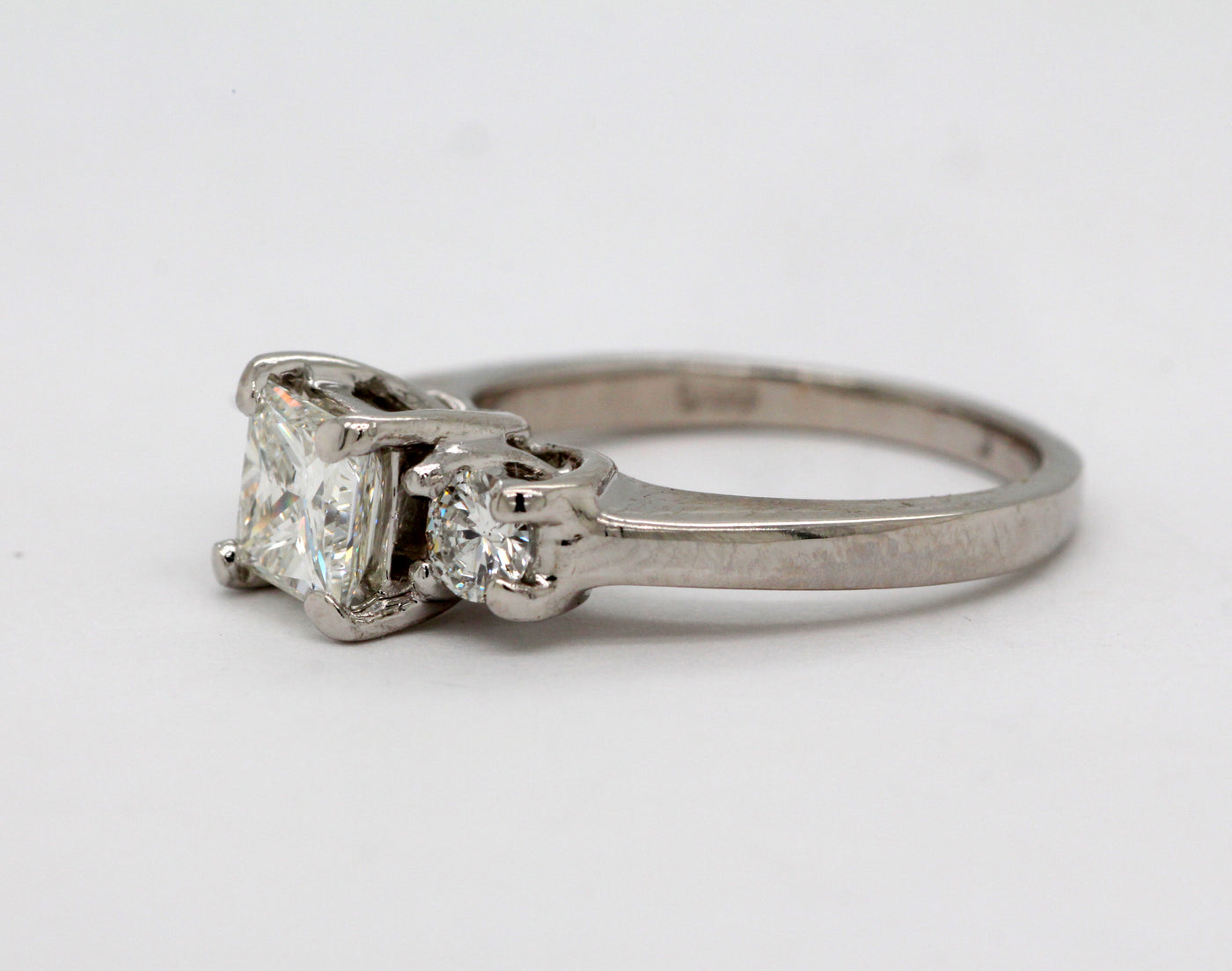 Platinum 3 stone ring with .90 Ct Princess cut Diamond, H in Color and