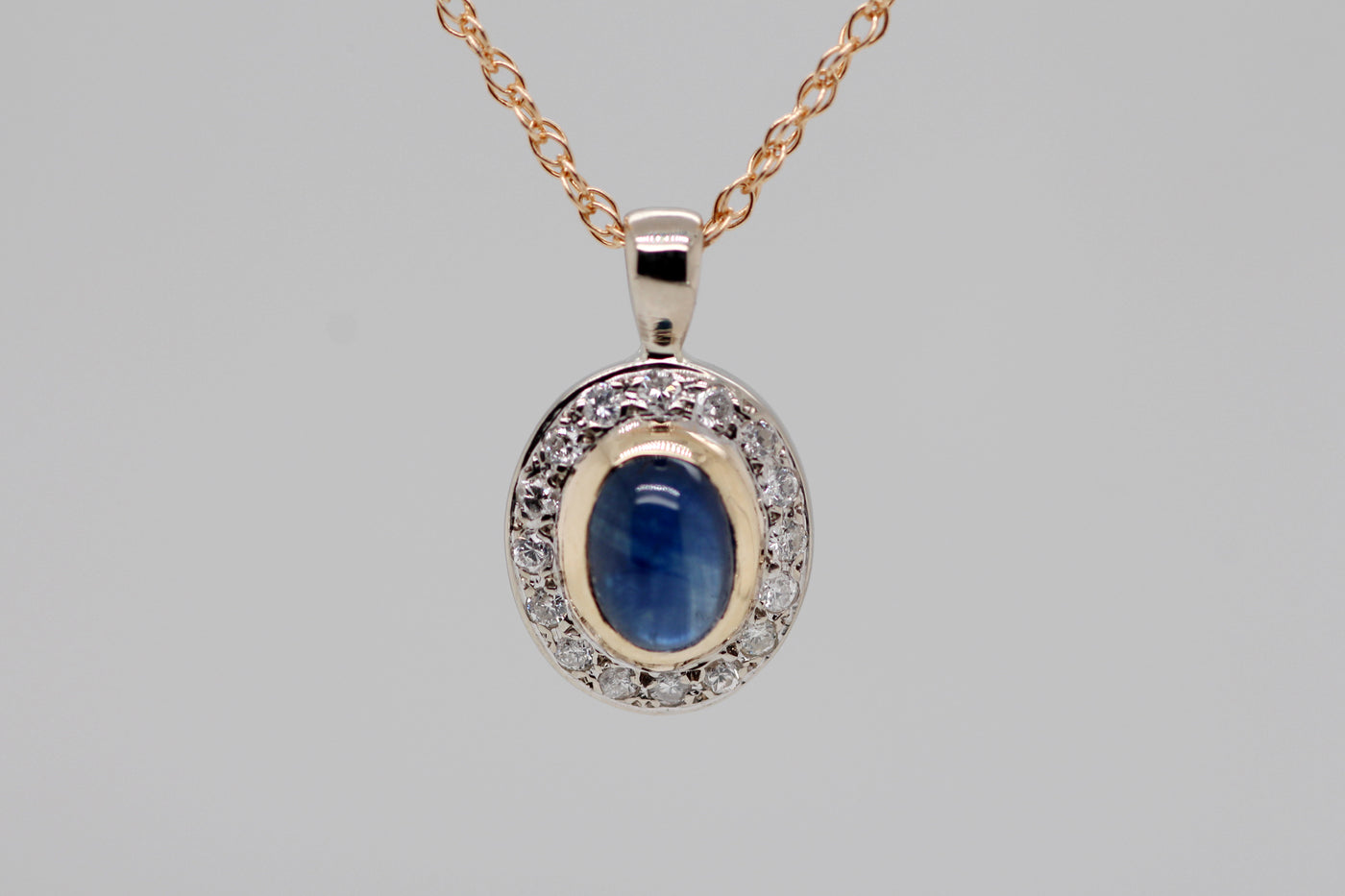 14KY 1.50 CT SAPPHIRE AND DIAMOND PENDANT .16 CTTW H-SI2