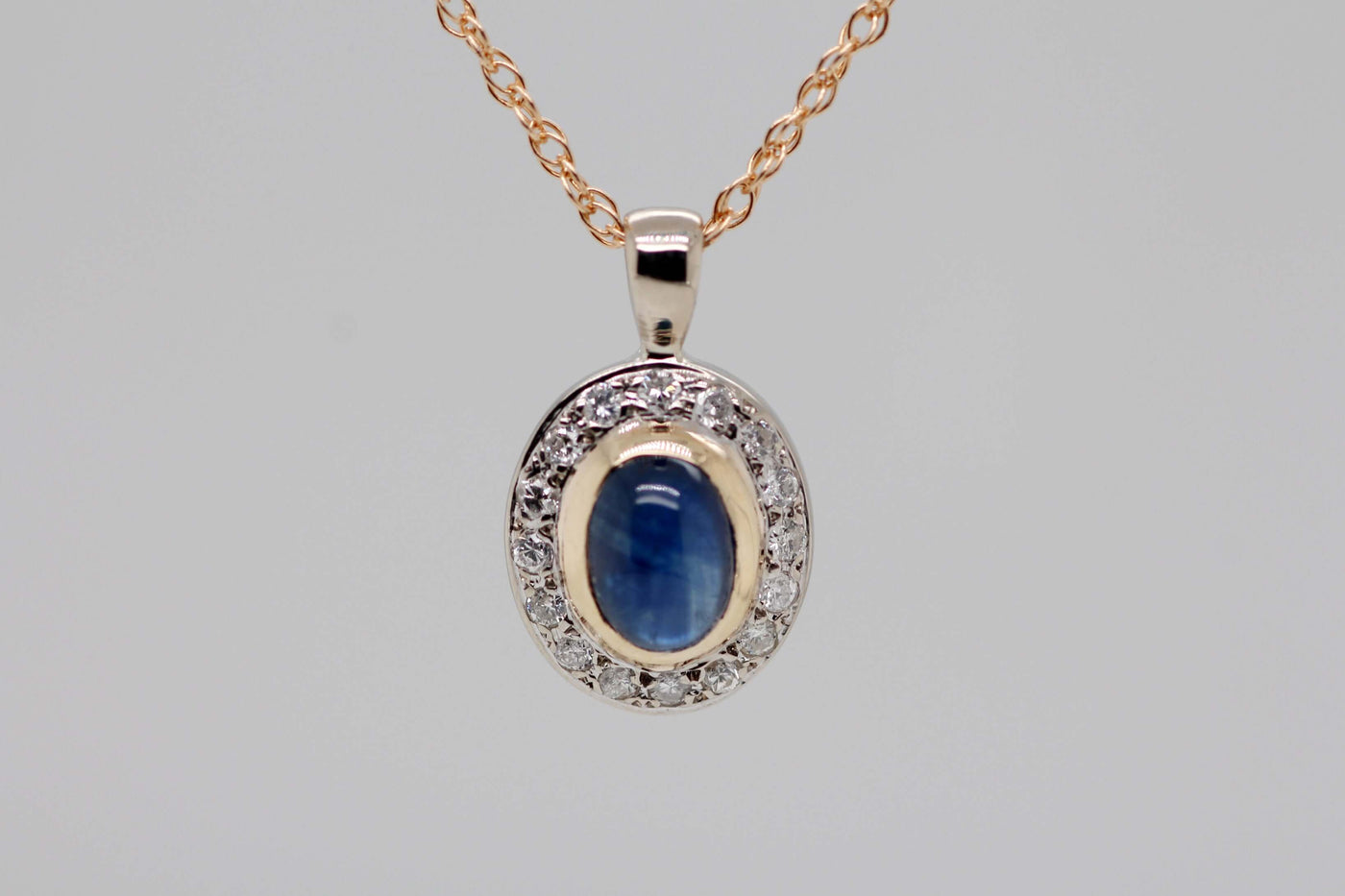 14KY 1.50 CT SAPPHIRE AND DIAMOND PENDANT .16 CTTW H-SI2