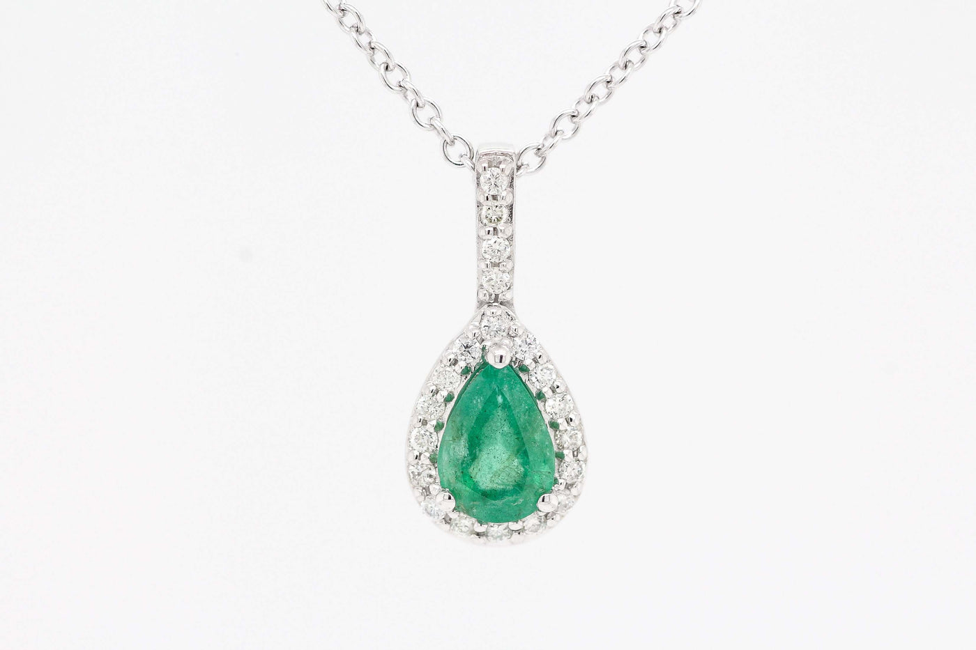 14KW .68 CT EMERALD AND DIAMOND PENDANT, .13 CTTW H-SI1
